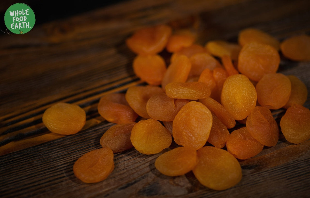 Dried large apricots from Whole Food Earth, GMO-free, vegan, dairy-free, no added sugar, showing ripe, orange apricots.