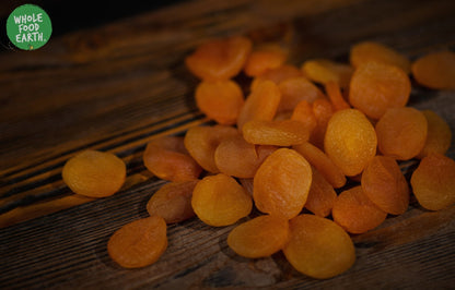 Dried large apricots from Whole Food Earth, GMO-free, vegan, dairy-free, no added sugar, showing ripe, orange apricots.