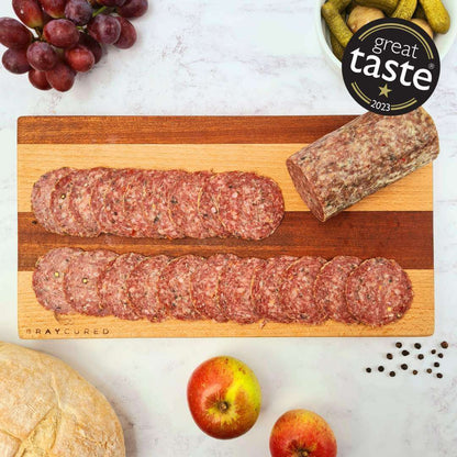 Wild garlic salami slices from Bray Cured charcuterie on a wooden board, showcasing a savory, herb-infused cured meat.