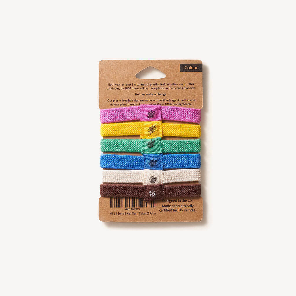 Six colorful plastic-free hair ties from Wild And Stone, shown in a 6-pack, made from eco-friendly materials for gentle hair styling.