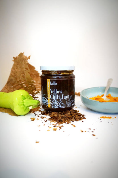 Laffe sustainable yellow chili jam in a jar, vibrant yellow color, smooth chili sauce with fresh chili ingredients visible